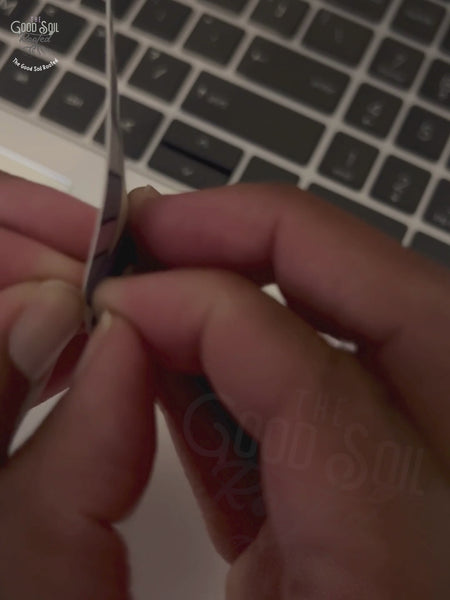 Short clip placing a sun and water designed scripture sticker onto a laptop